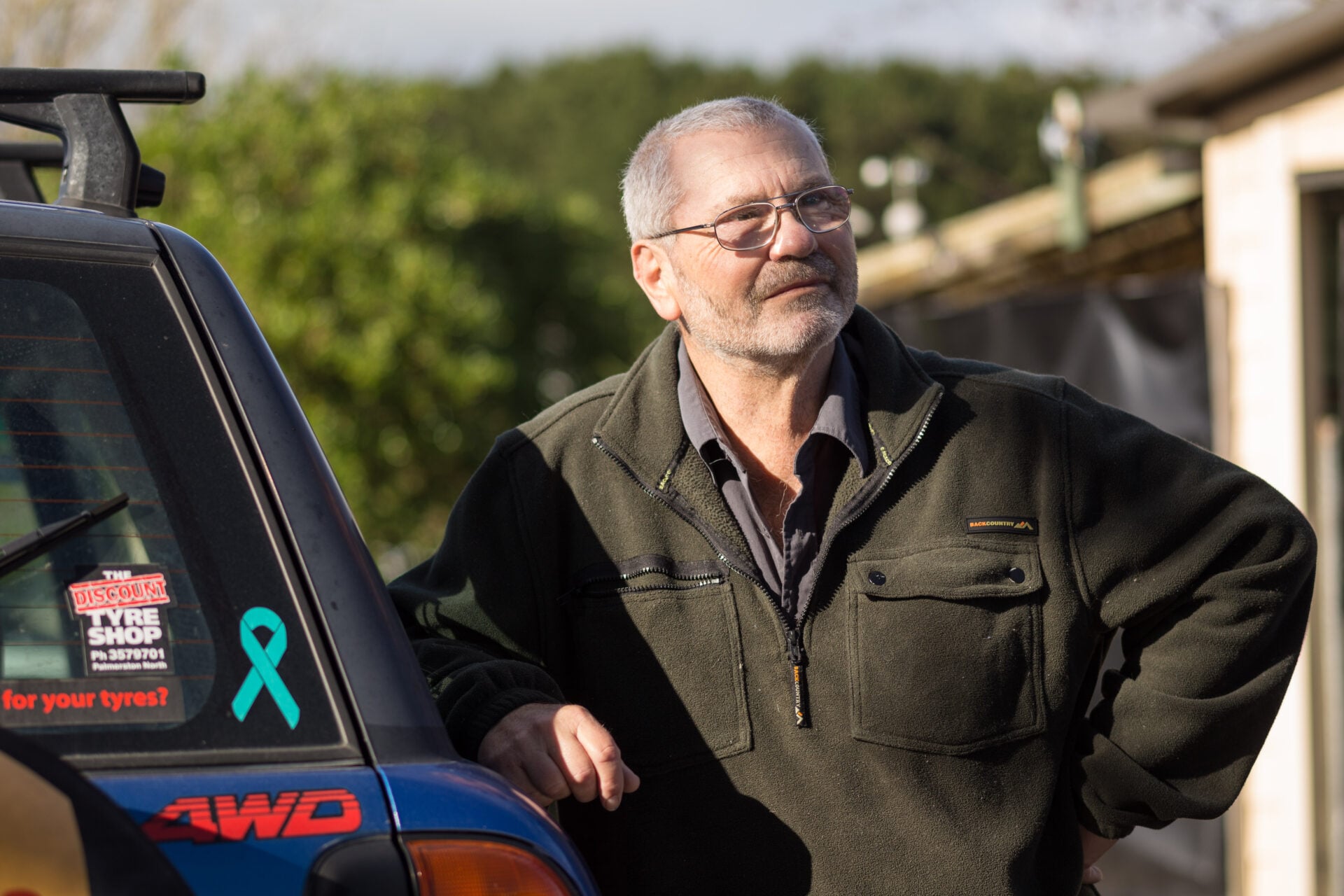 Decorative picture on man standing next to a car