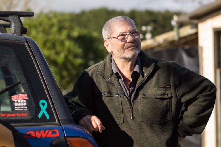 Decorative picture on man standing next to a car