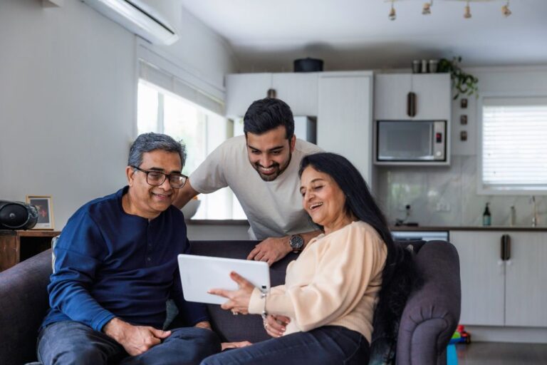 An older couple showing their son their ipad