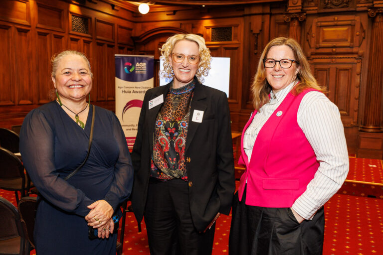 Three older adults side by side in a photo in Parliament