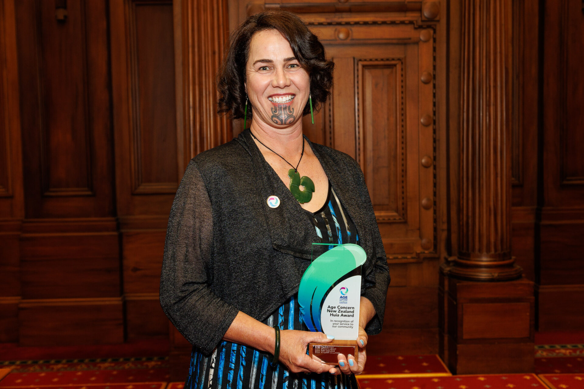 Irihapeti Bullmore carrying the green huia award