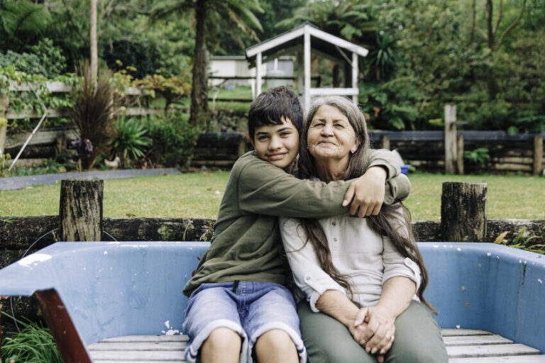 Young child hugging older adult