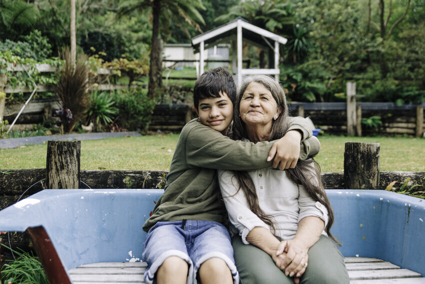 Young child hugging older adult